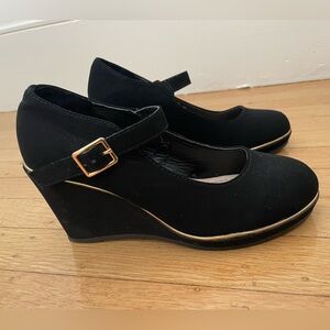 Black suede-like wedge heel Mary Jane shoes with gold accents, size 5.5